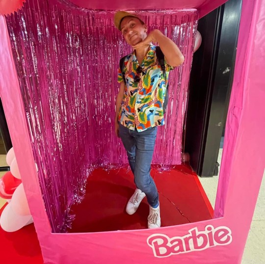 Jason Reid posing in a pink Barbie ⁢tent